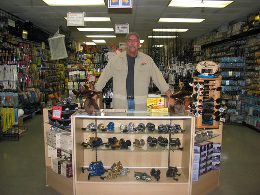 Mark behind the reel counter of the CharkBait tackle shop in Huntington Beach, 2004