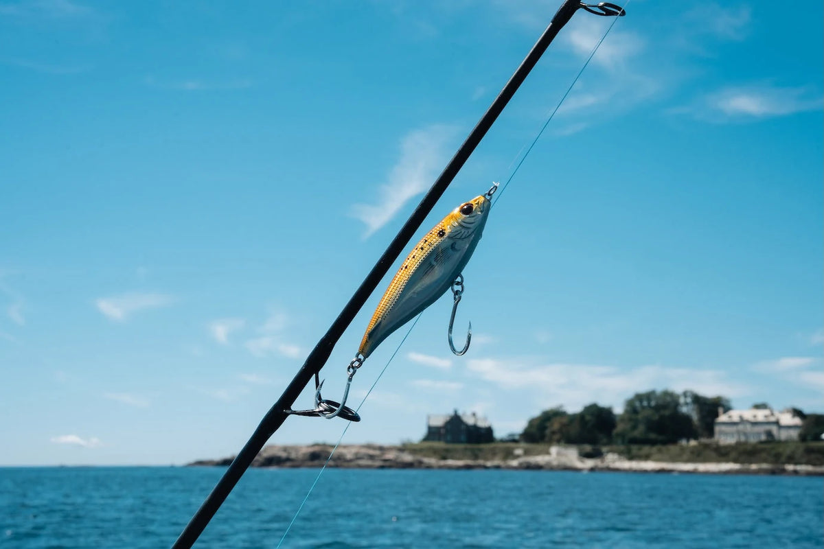 Nomad Design MadScad Auto Tune stickbait hanging from a rod tip on the water