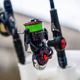 Daiwa Ballistic MQ LT spinning reel spooled with braid, in a rod holder on the water