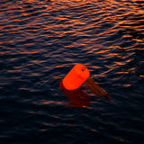Glow Buoy LED float glowing red on the water at night