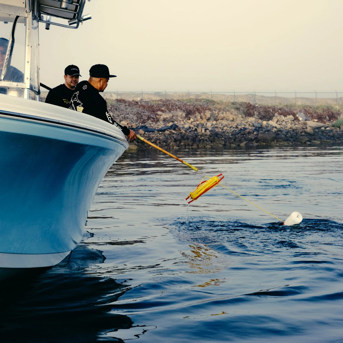 Hooking a Glow Buoy float to pull a net from the boat