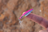 Nomad Design Buffalo Jr Micro Jig in Pink Sardine held on a fingertip