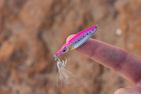 Nomad Design Buffalo Jr Micro Jig in Pink Sardine held on a fingertip