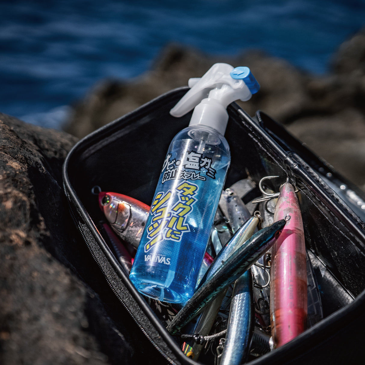 Varivas Salt Neutralizing Spray standing in a tackle case full of lures at the coast